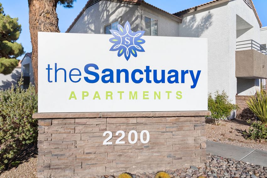 a picture of the sign at the sanctuary apartments in grand prairie, tx - Photo Gallery 1